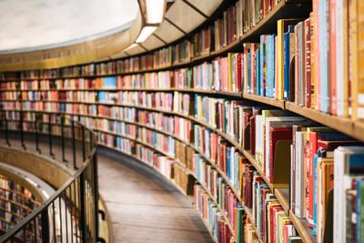 A picture of a library with a big curved wall of books