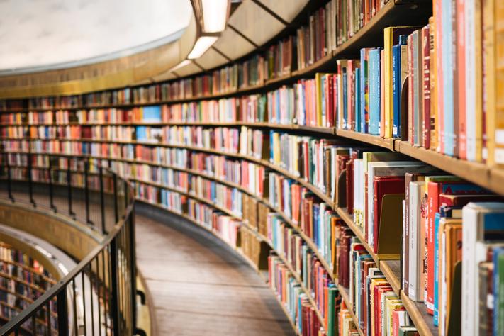 A picture of a library with a big curved wall of books